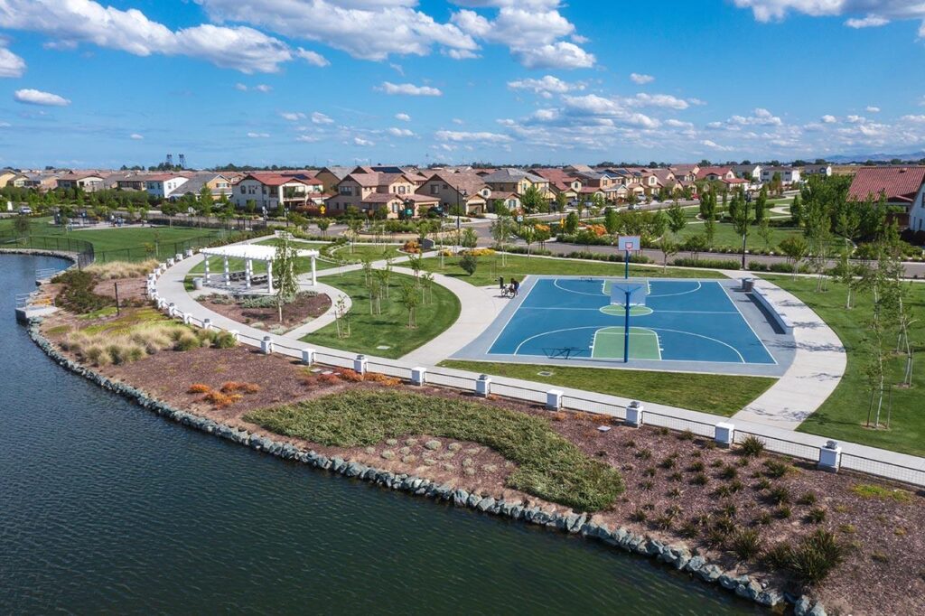 Crystal Cove Park at River Islands in Lathrop with a baseball diamond, basketball court, and lakeside views