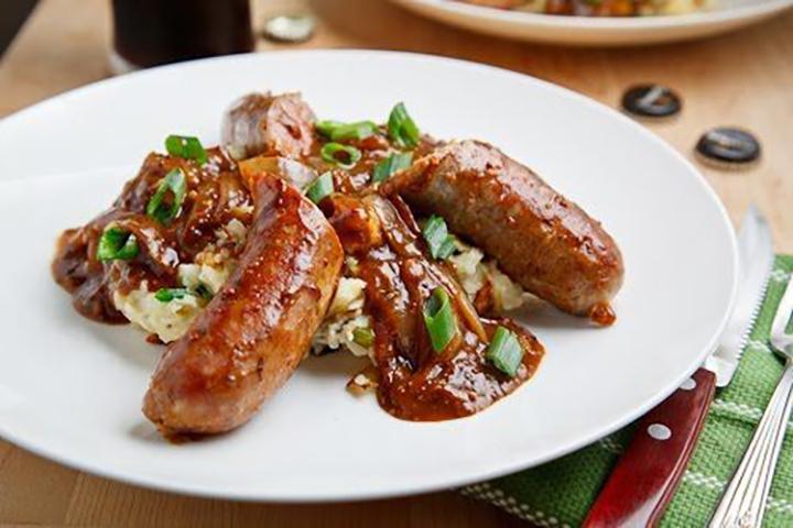 bangers and colcannon on white plate