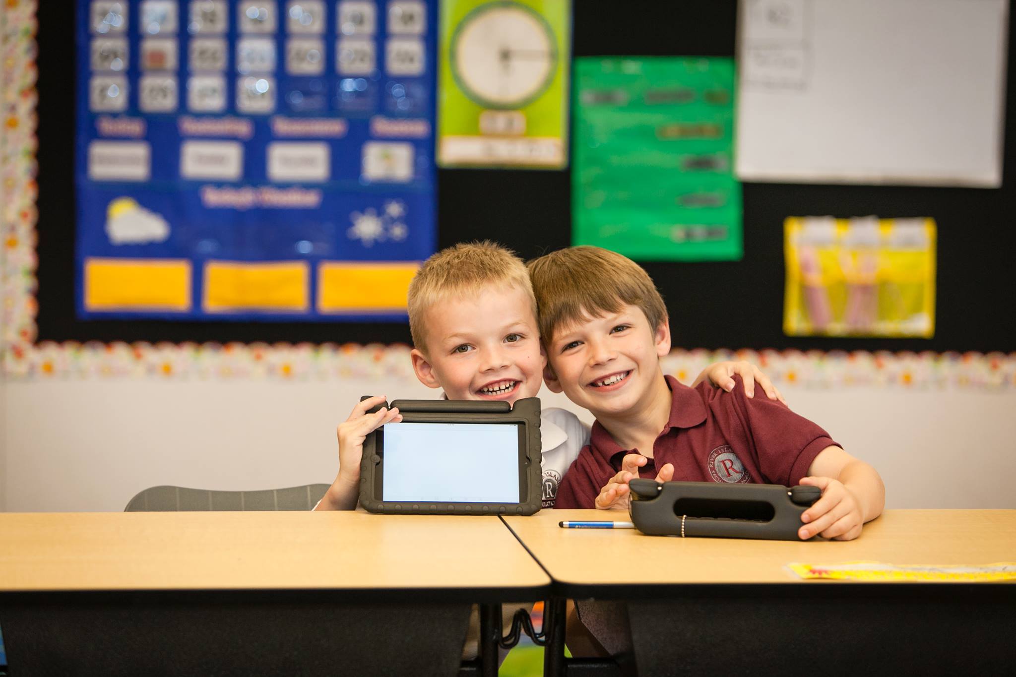two kids with tablets in classroom at River Islands