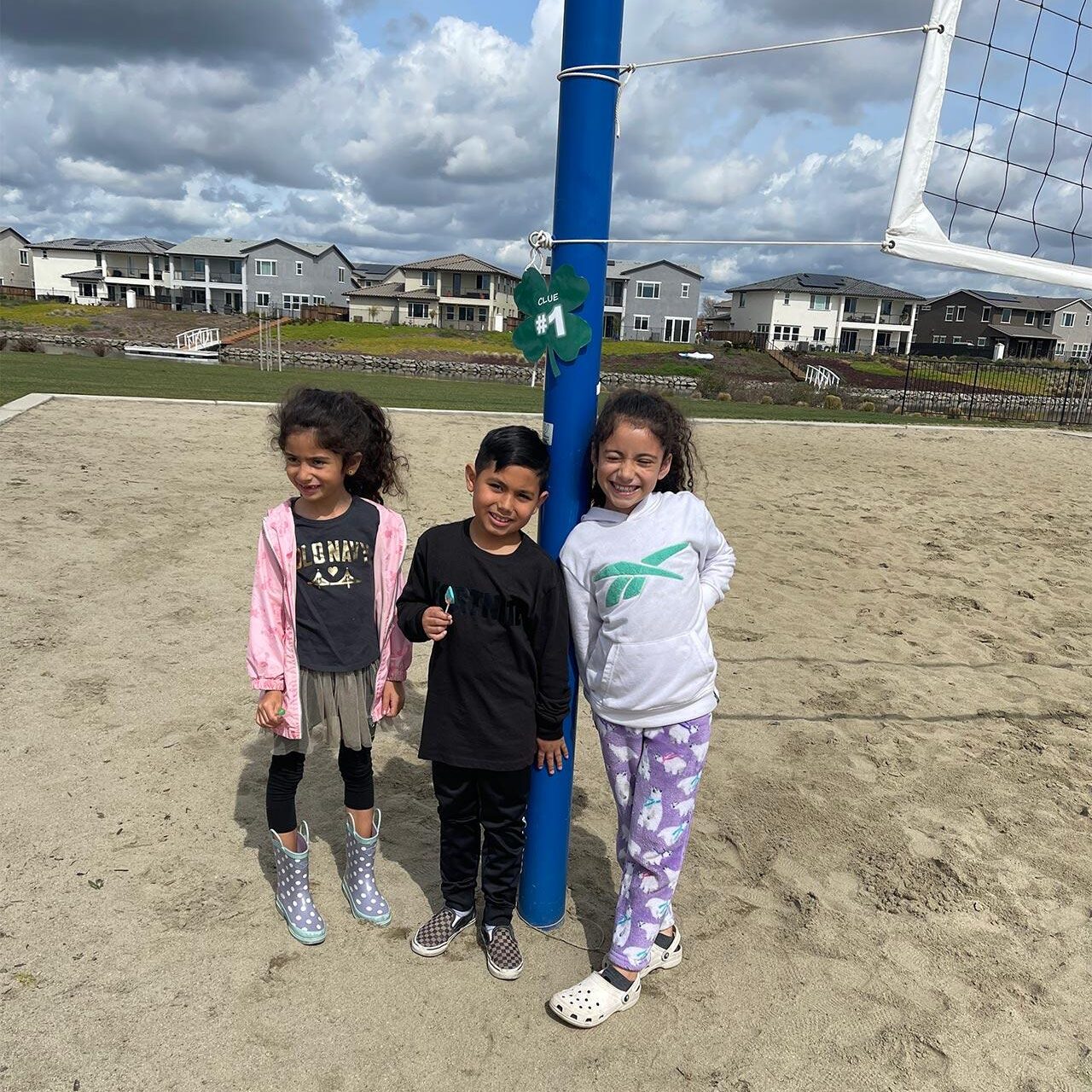 three children on volleyball court at River Islands in Lathrop