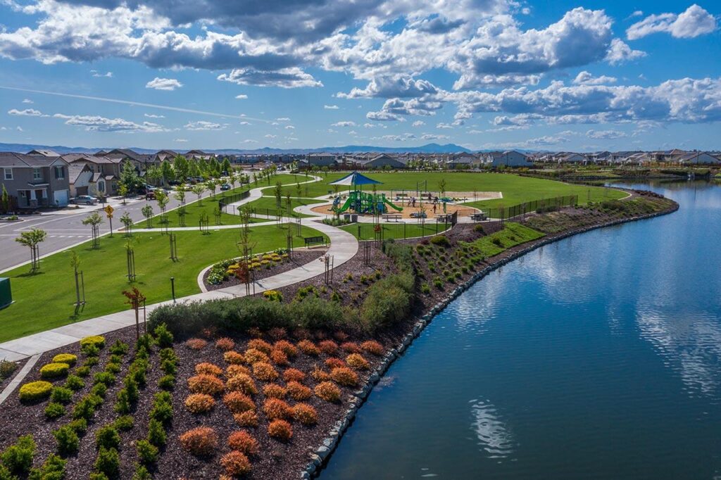 Reflection Park at River Islands in Lathrop with lakeside views, walking paths, basketball court, volleyball court, and open green space
