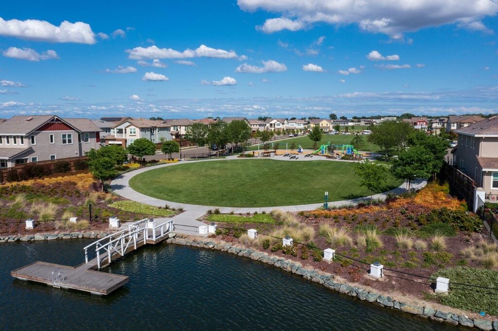 Somerston Park at River Islands in Lathrop with lakeside views, walking path, and jungle gym for kids