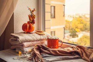 (pile-of-cozy-blankets-with-leaves-and-pumpkins; 37.80226789590045, -121.32193629810645)